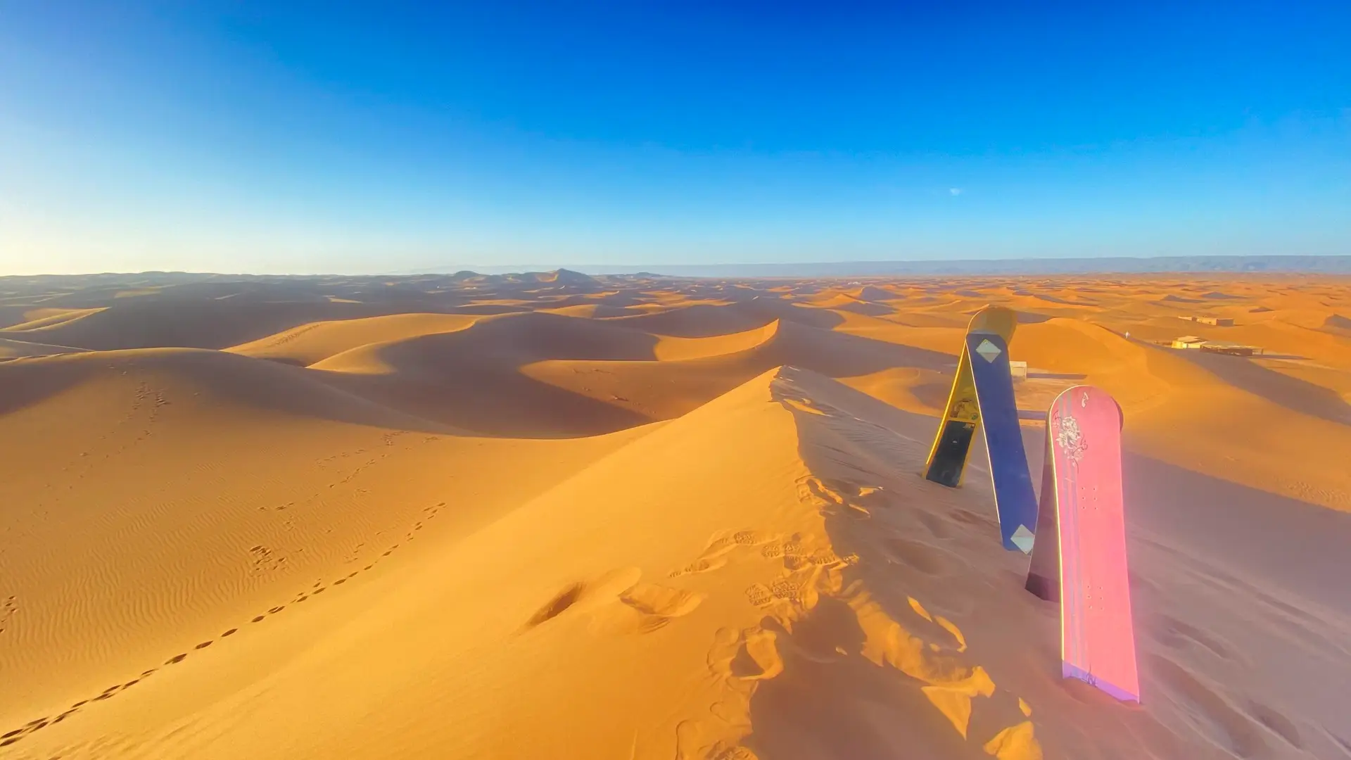 Morocco Tour Packages sandboarding in erg chigaga