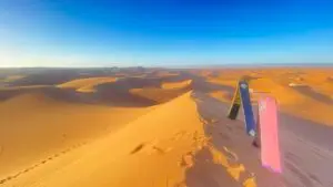 Morocco Tour Packages sandboarding in erg chigaga